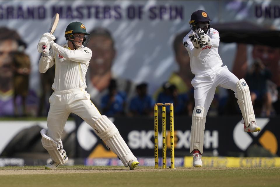 Australia's Alex Carey plays a shot as Sri Lankan wicketkeeper Niroshan Dickwella watches during the day two of the first test cricket match between Australia and Sri Lanka in Galle, Sri Lanka, Thursday, June 30, 2022. (AP Photo/Eranga Jayawardena)