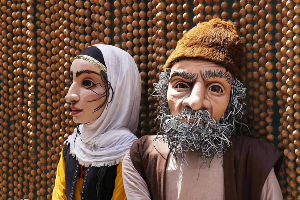 Two large puppets sit off to the side of Iran's pavilion at Expo 2020 in Dubai, United Arab Emirates, Saturday, Oct. 2, 2021. Dubai has gambled billions to make the gleaming, built-from-scratch Expo village a triumphant tourist attraction and symbol of the United Arab Emirates itself — a feast for the eyes devoid of politics and built on the promise of globalization. But even as nations use their pavilions for benign infomercials, the political turbulence of the wider world somehow manages to intrude. (AP Photo/Jon Gambrell)