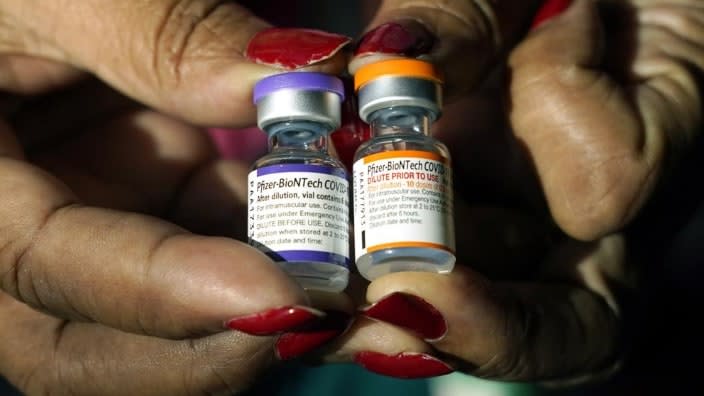 A nurse holds a vial of the Pfizer COVID-19 vaccine for children ages 5 to 11 (right) and a vial of the vaccine for adults, which has a different colored label, at a vaccination station in Jackson, Miss. (Photo: Rogelio V. Solis/AP, File)