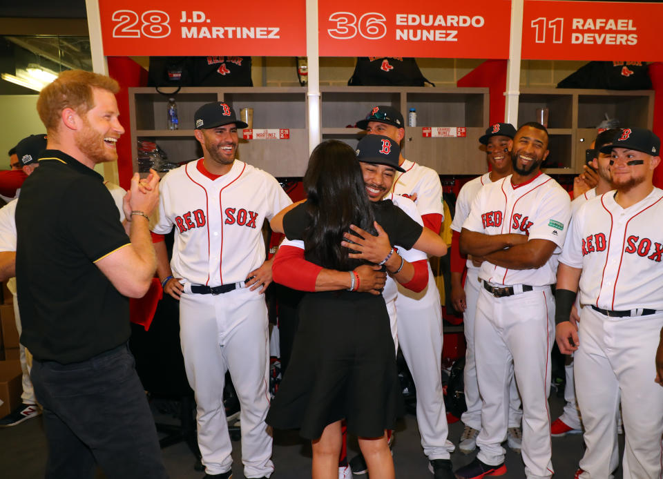 LONDON, ENGLAND - JUNE 29:  Meghan, Duchess of Sussex greets distant relative Mookie Betts #50 of the Boston Red Sox while Prince Harry, Duke of Sussex looks on in the Red Sox clubhouse before game one of the London Series between the New York Yankees and the Boston Red Sox at London Stadium on Saturday, June 29, 2019 in London, England. (Photo by Alex Trautwig/MLB via Getty Images)