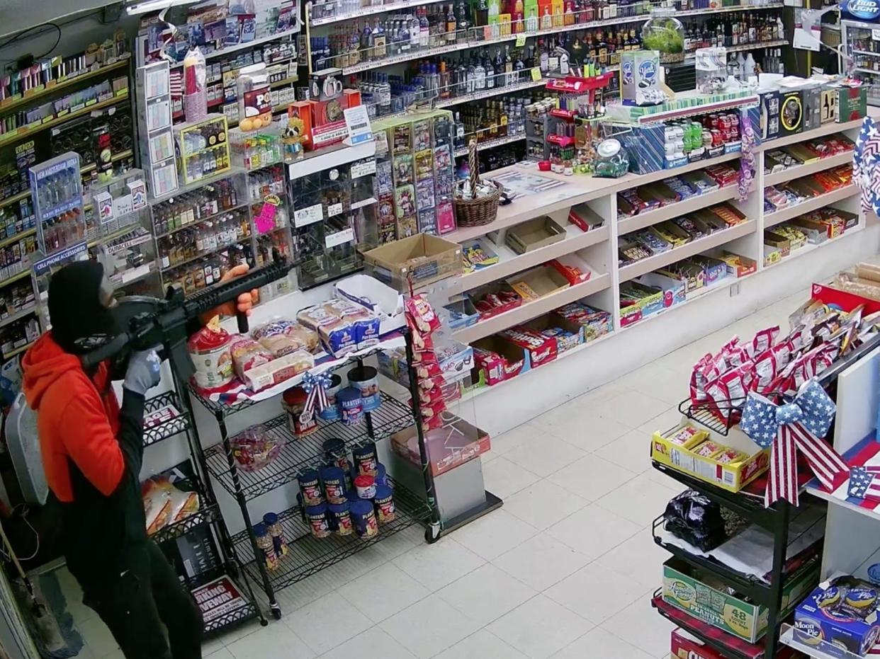 Footage shows an armed gunman in Craig Cope's California store.