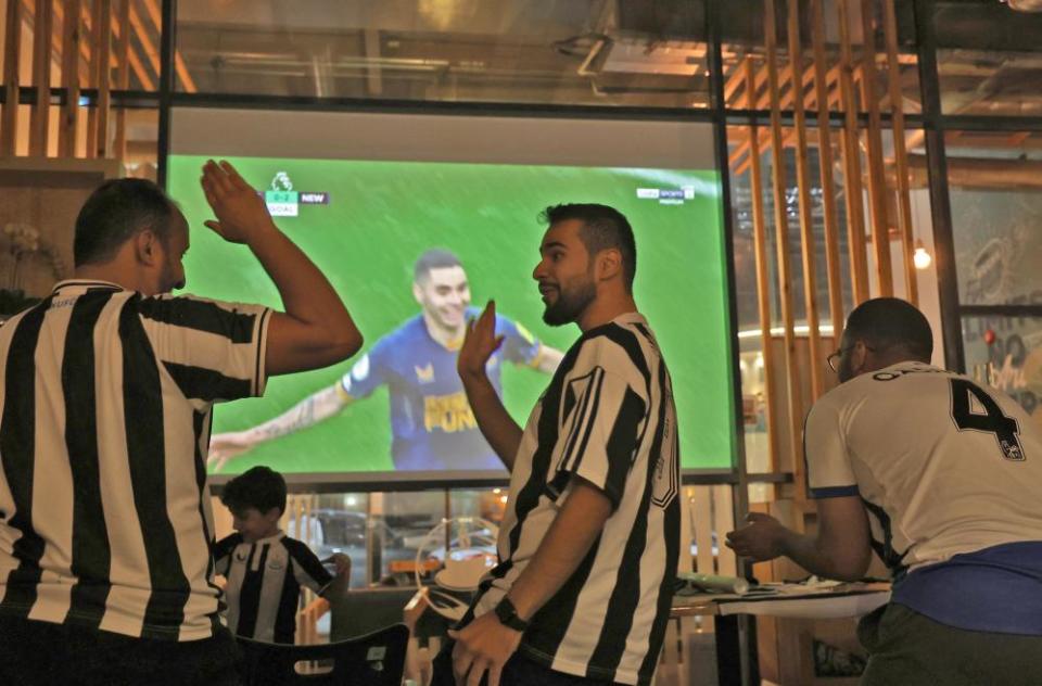 Saudi fans of Newcastle United celebrate a goal scored against Tottenham as they watch the match at a cafe in Riyadh last October.