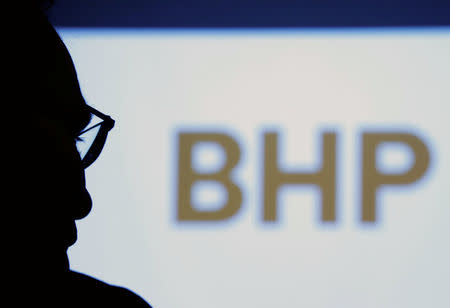 FILE PHOTO - BHP Billiton Chief Executive Andrew Mackenzie is silhouetted against a screen projecting the company's logo at a round table meeting with journalists in Tokyo, Japan June 5, 2017. REUTERS/Kim Kyung-Hoon/File photo