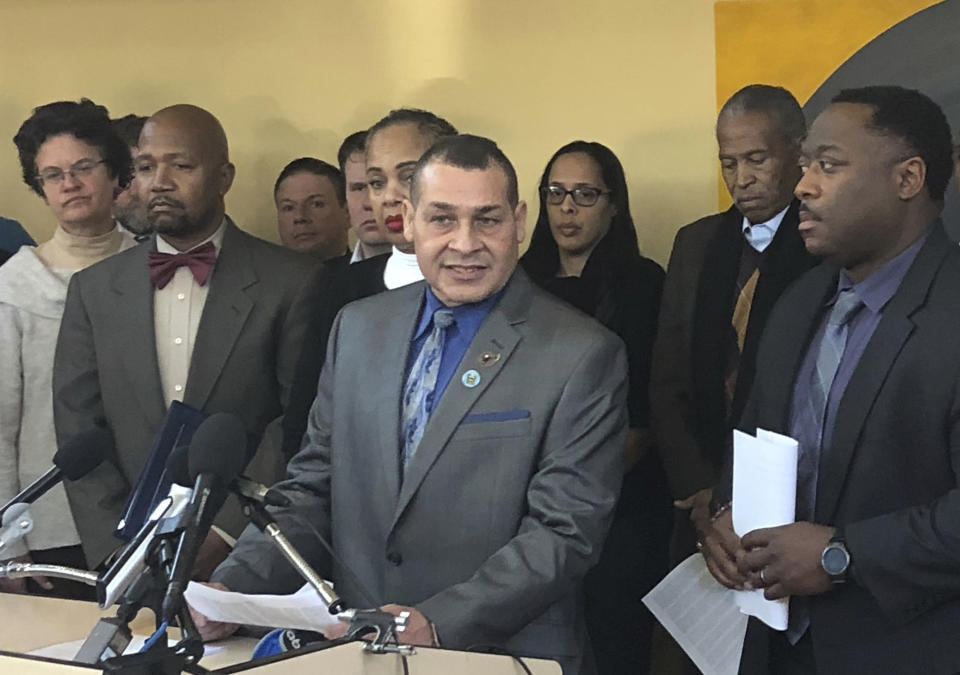 Prince George's County Police Capt. Joseph Perez, center, a plaintiff and president of Hispanic National Law Enforcement Association National Capital Region, speaks during a news briefing in unincorporated Prince George County, near College Park, Md. Wednesday, Dec. 12, 2018. White police officers in a Washington, D.C., suburb have used racist slurs, circulated text messages expressing a desire to “reinstitute lynching” and put a black face and Afro wig on a training dummy, according to a federal lawsuit filed Wednesday. (AP Photo/Michael Kunzelman)