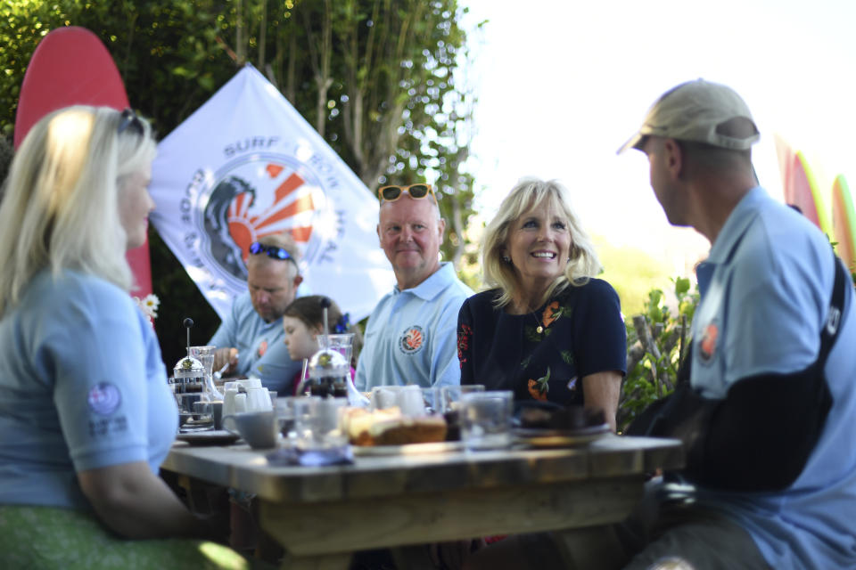 US First Lady Jill Biden meets military surfers and their families in Newlyn, Cornwall, England, on the sidelines of the G7 summit, Saturday June 12, 2021. US First Lady Jill Biden met with veterans, first responders and family members of Bude Surf Veterans, a Cornwall-based volunteer organization that provides social support and surfing excursions for veterans, first responders and their families. (Daniel Leal-Olivas/Pool via AP)