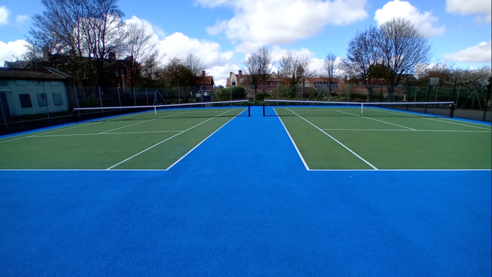 A picture of two refurbished tennis courts 
