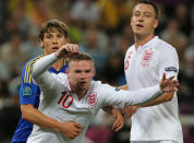 Ukrainian midfielder Denys Garmash (L) vies with English forward Wayne Rooney and English defender John Terry (R) during the Euro 2012 football championships match England vs Ukraine on June 19, 2012 at the Donbass Arena in Donetsk. AFP PHOTO / ALEXANDER KHUDOTEPLYAlexander KHUDOTEPLY/AFP/GettyImages