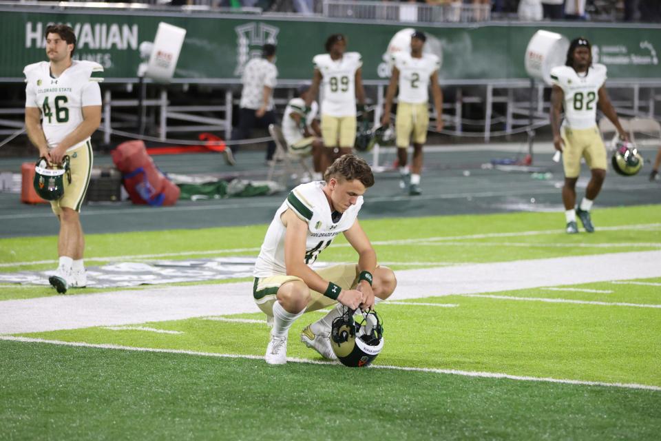 Colorado State players react after losing to Hawaii during the second half of an NCAA college football game, Saturday, Nov. 25, 2023, in Honolulu. (AP Photo/Marco Garcia)