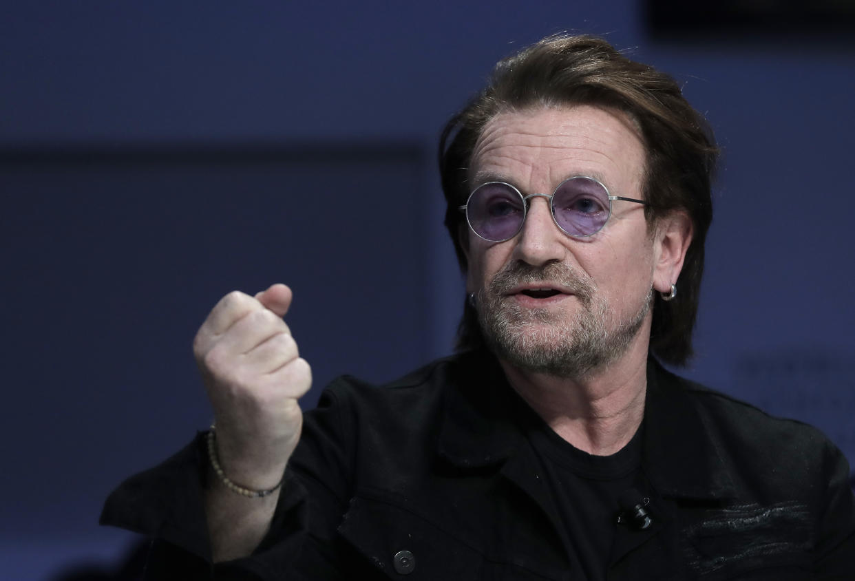 Singer and co-founder of RED Bono gestures while participating in the "Closing the Financing Gap" session at the annual meeting of the World Economic Forum in Davos, Switzerland, Wednesday, Jan. 23, 2019. (AP Photo/Markus Schreiber)