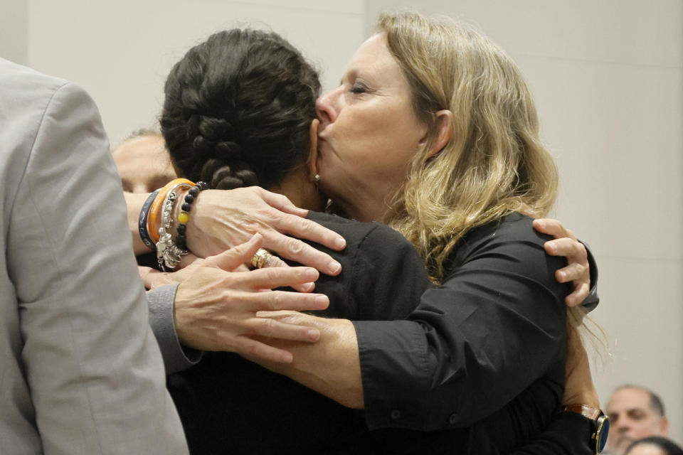 Debbie Hixon, right, kisses her daughter-in-law, Ines Hixon, after she gave a victim impact statement in the sentencing hearing for Marjory Stoneman Douglas High School shooter Nikolas Cruz at the Broward County Courthouse in Fort Lauderdale, Fla. on Tuesday, Nov. 1, 2022. Debbie Hixon's husband, Christopher, was killed in the 2018 shootings. Cruz was sentenced to life in prison for murdering 17 people at Parkland's Marjory Stoneman Douglas High School more than four years ago. (Amy Beth Bennett/South Florida Sun Sentinel via AP, Pool)