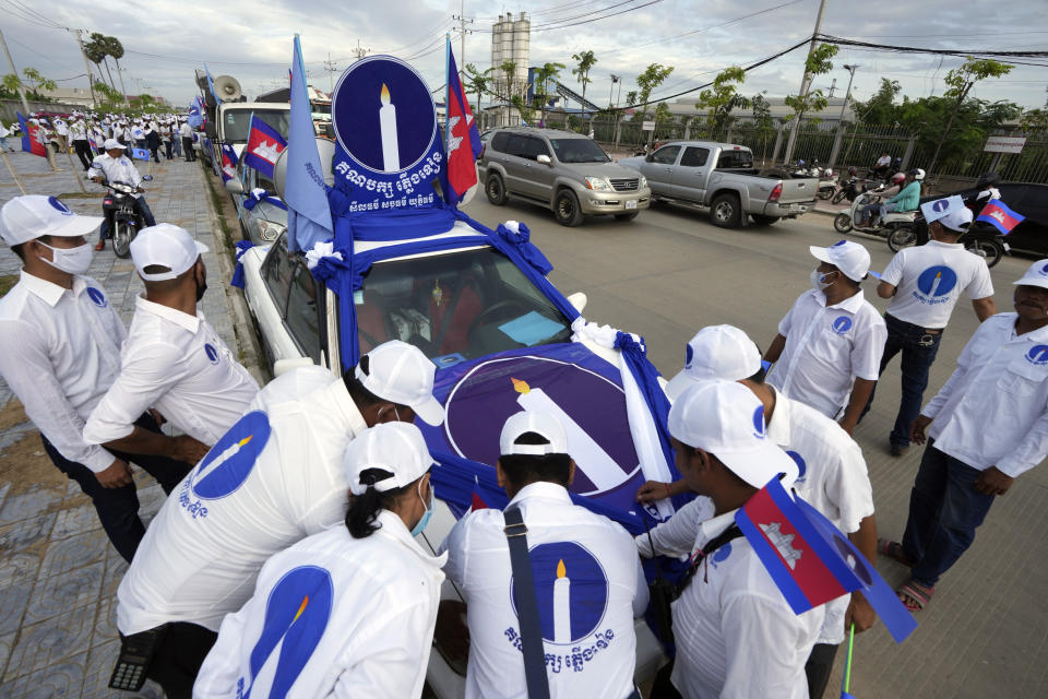 Candlelight Party supporters register on the participant lists near their party's logo before their march during an election campaign for the June 5 communal elections in Phnom Penh, Cambodia, Saturday, May 21, 2022. Cambodia's National Election Committee on Monday, May 15, 2023, refused to register the Candlelight Party, the country's sole credible challenger to the governing Cambodian People's Party, for participation in this July election, saying it had failed to provide the necessary documents. (AP Photo/Heng Sinith)