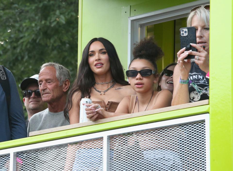 Casie watches a concert alongside Megan Fox