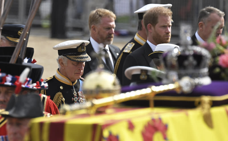 King Charles III, left, and Prince Harry, Duke of Sussex, follow the coffin of Queen Elizabeth II, draped in the Royal Standard, as it travels on the State Gun Carriage of the Royal Navy, from Westminster Abbey to Wellington Arch State.