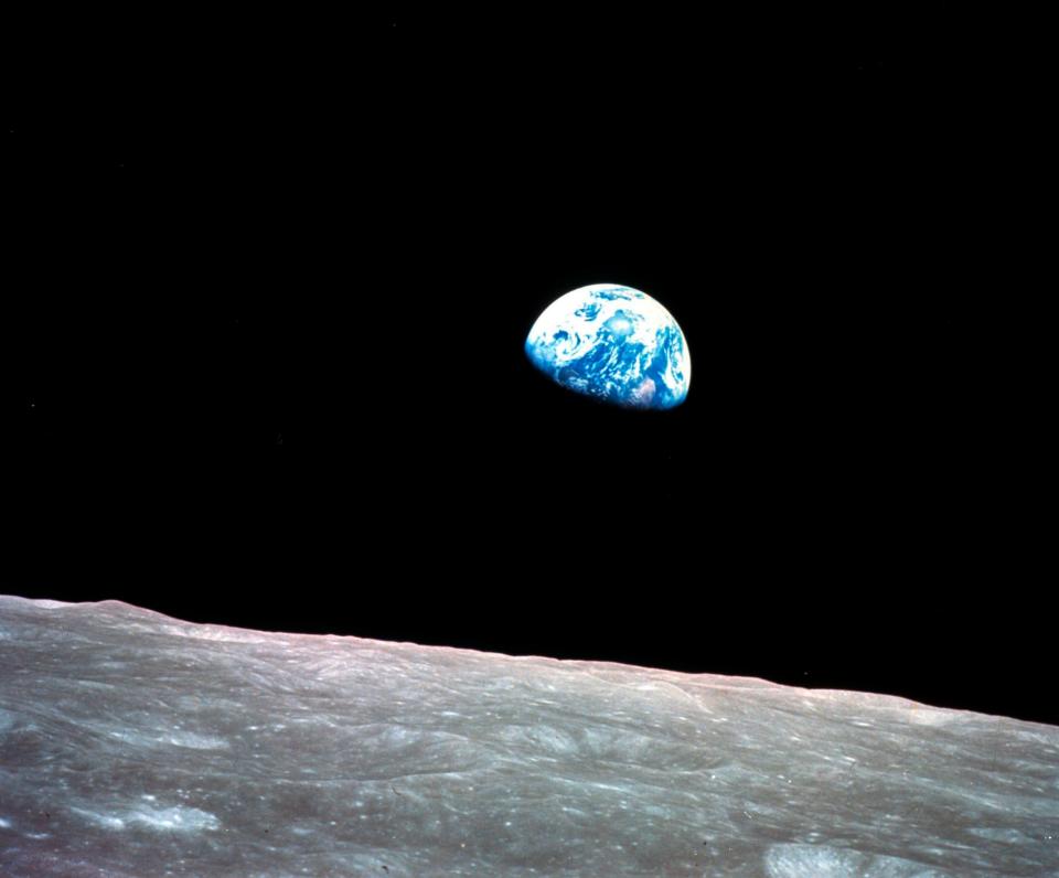 FILE - This December 24, 1968 file photo provided by NASA shows Earth behind the surface of the moon during the Apollo 8 mission.  Retired Maj. Gen. William Anders, the former Apollo 8 astronaut who took the iconic 