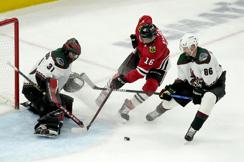 Arizona Coyotes' Anton Stralman (86) keeps Chicago Blackhawks' Jujhar Khaira (16) from getting a clean shot on goalie Scott Wedgewood during the third period of an NHL hockey game Friday, Nov. 12, 2021, in Chicago. The Blackhawks won 2-1. (AP Photo/Charles Rex Arbogast)