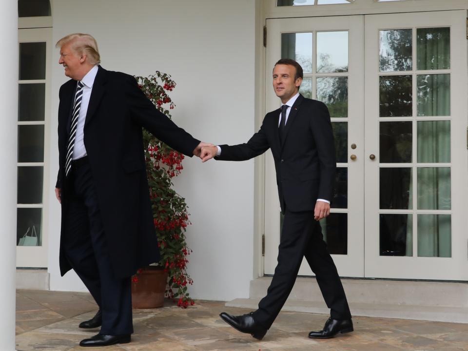 French President Emmanuel Macron and Donald Trump walk hand in hand under the colonnades of the White House in Washington on 24 April 2018AFP via Getty Images