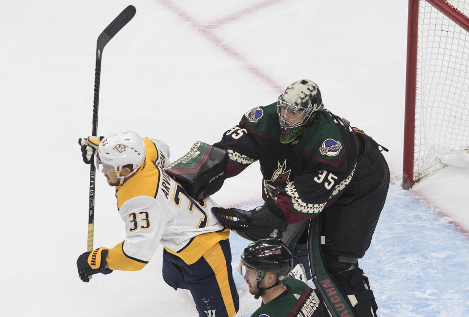 Nashville Predators' Viktor Arvidsson (33) is cross checked by Arizona Coyotes goalie Darcy Kuemper (35) during first period NHL hockey action in Edmonton, Alberta, Friday, Aug. 7, 2020. (Jason Franson/The Canadian Press via AP)