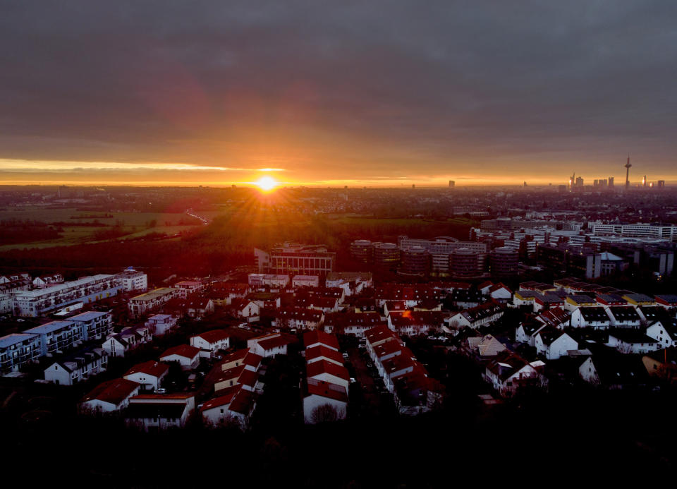 The sun rises over Frankfurt, Germany, Monday, Dec. 14, 2020. Germany goes into a lockdown on Wednesday, Dec. 16, 2020. (AP Photo/Michael Probst)