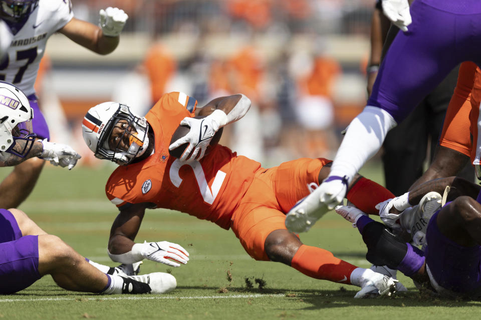 Virginia's Perris Jones (2) is tackled during an NCAA college football game against James Madison in Charlottesville, Va., on Saturday, Sept. 9, 2023. (AP Photo/Mike Kropf)