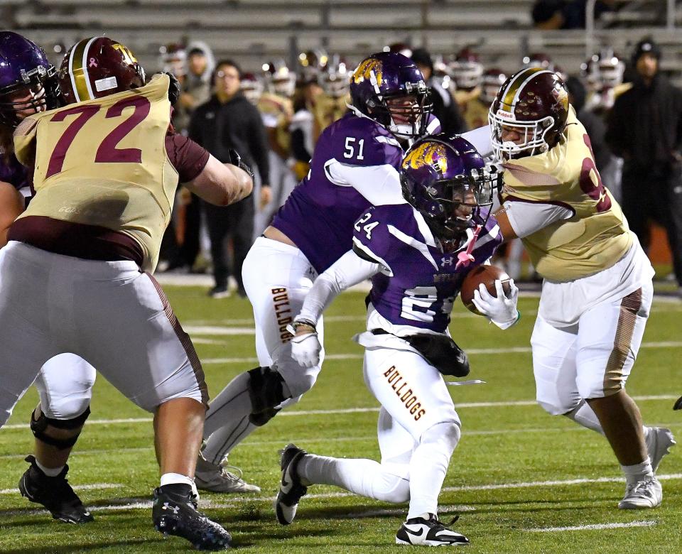 Wylie running back Jaden Lucero carries the football through the El Paso Andress line during Friday’s Class 5A Div. II bi-district playoff game at Hugh Sandifer Stadium in Abilene.