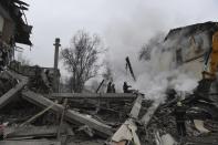 Smoke rises as Donetsk's emergency employees work at a site of a shopping center destroyed after what Russian officials in Donetsk said it was a shelling by Ukrainian forces, in Donetsk, in Russian-controlled Donetsk region, eastern Ukraine, Monday, Jan. 16, 2023. (AP Photo)