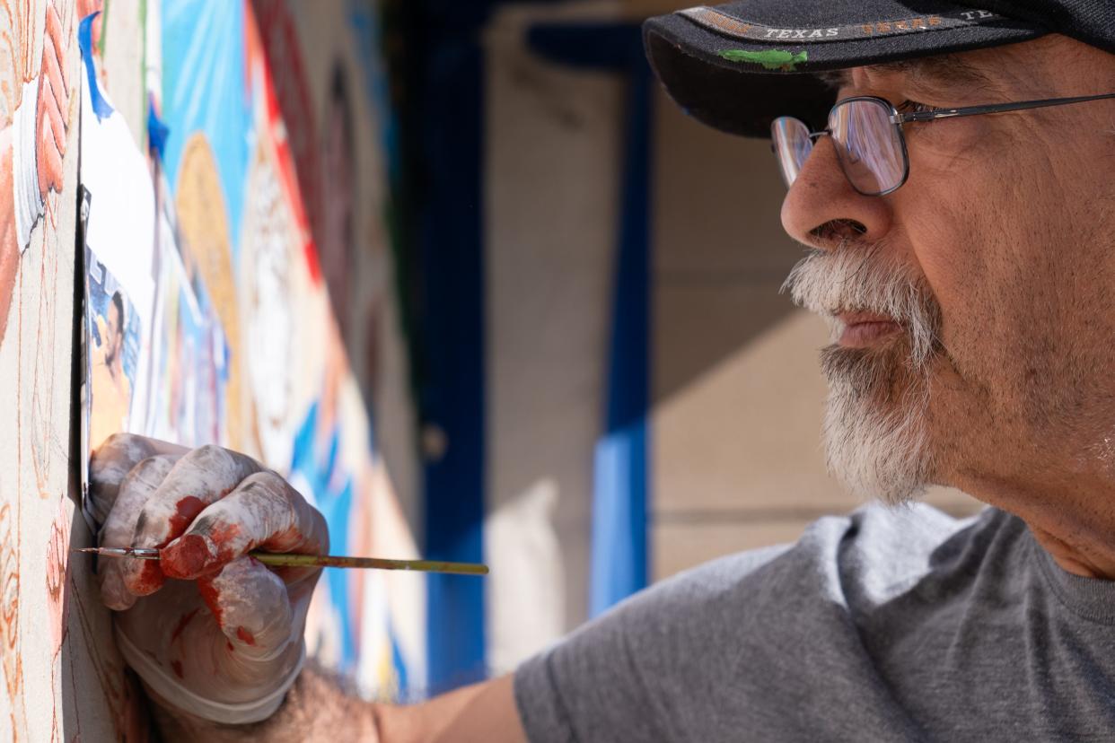 Details like the strings of a racket or the texture of a tennis ball are painstakingly brushed in by Andy Valdivia in his latest mural at Kossover Tennis Center.