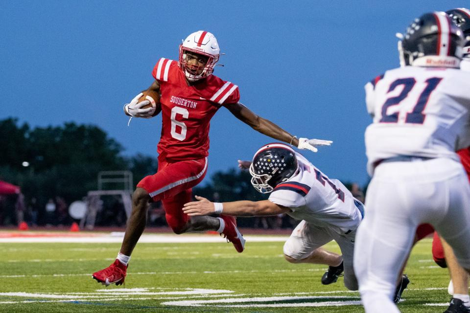 Souderton wide receiver Danny Dyches eludes Central Bucks East linebacker Dan Voglesong on Friday night.