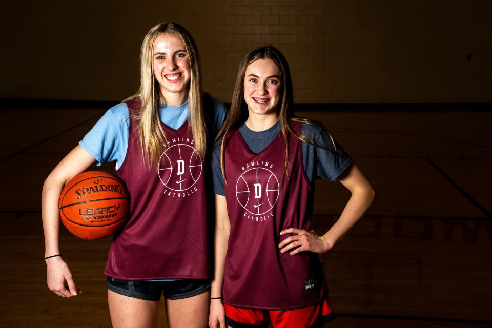 Dowling Catholic girls basketball players and sisters Ellie, left, and Katie Muller, right, are loving playing together at the varsity level.