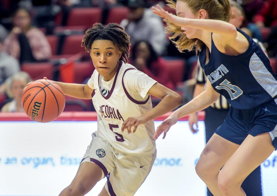 Peoria High's Danielle Ruffin (5) moves the ball against Nazareth Academy's Mary Bridget Wilson in the second half of the Class 3A state semifinals Friday, March 3, 2023 at CEFCU Arena in Normal. The Lions fell to the Roadrunners 48-35.