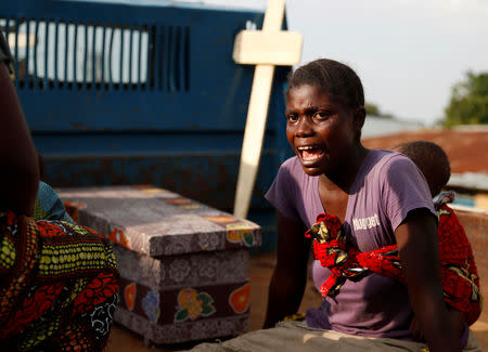 FILE PHOTO: A woman cries during the funeral of a child, suspected of dying from Ebola, next to the coffin in Beni, North Kivu Province of Democratic Republic of Congo, December 17, 2018. REUTERS/Goran Tomasevic/File Photo