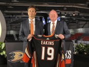 Anaheim Ducks head coach Dallas Eakins, left, and general manager Bob Murray pose with a jersey at Great Park Ice in Irvine, Calif., Monday, June 17, 2019. Eakins was hired as the Ducks' head coach on Monday, moving up from their AHL affiliate to take over a longtime NHL power that stumbled last season. (AP Photo/Greg Beacham)