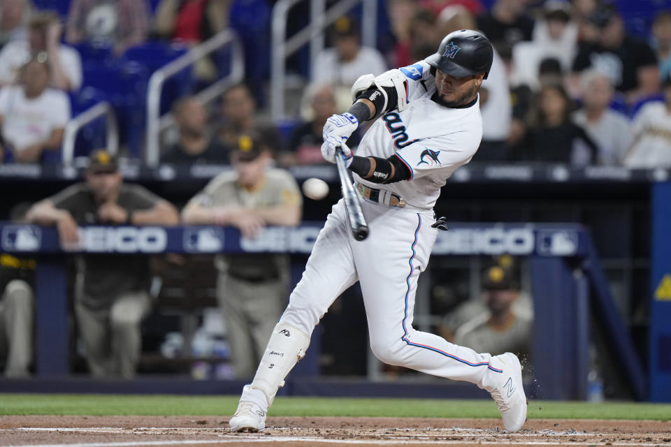 Miami Marlins' Luis Arraez gets a base hit during the first inning of a baseball game against the San Diego Padres, Wednesday, May 31, 2023, in Miami. (AP Photo/Wilfredo Lee)
