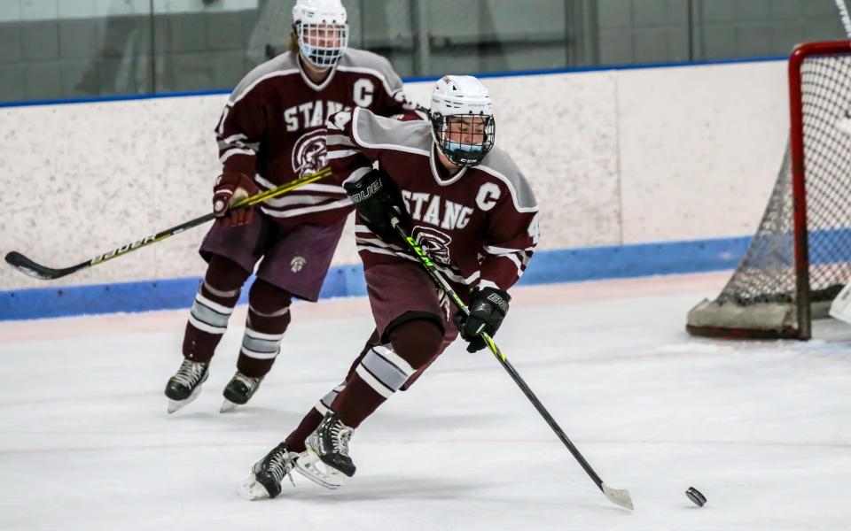 Bishop Stang's Jack Jedrey begins a rush up ice while Seamus Marshall follows the play during the first period of the Spartans' preseason matchup with GNB Voc Tech on Wednesday night.