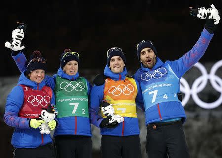 Biathlon - Pyeongchang 2018 Winter Olympics - Mixed Relay Final - Alpensia Biathlon Centre - Pyeongchang, South Korea - February 20, 2018 - Gold medalists: Martin Fourcade, Simon Desthieux, Marie Dorin Habert and Anais Bescond of France celebrate during the victory ceremony. REUTERS/Murad Sezer