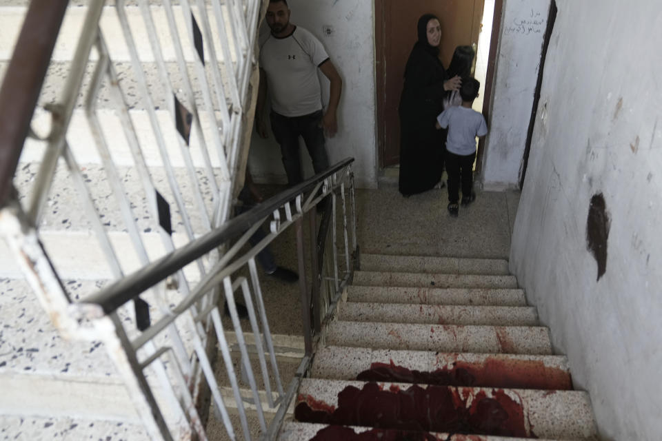 Blood pools on the steps of an apartment building where a Palestinian civilian was shot by an Israeli sniper while filming a military raid, that also killed a militant in the Balata refugee camp in the West Bank city of Nablus, Monday, June 3, 2024. Palestinian authorities said two men were shot dead by Israeli forces during a raid in the occupied West Bank on Monday. According to Israeli police, the raid took place in the northern city of Nablus. (AP Photo/Majdi Mohammed)