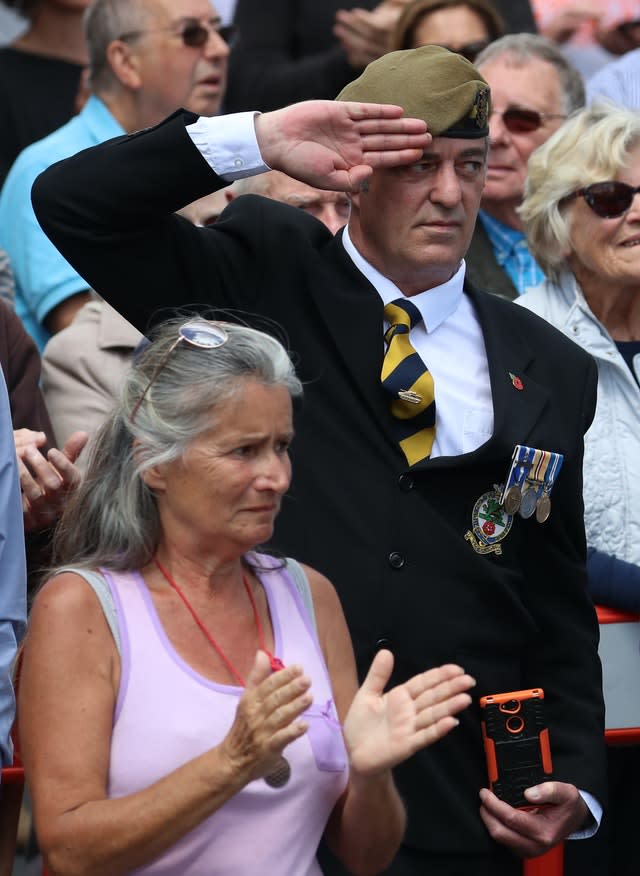 A man salutes the funeral cortege