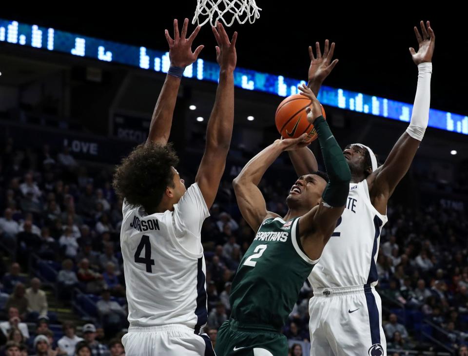 Michigan State guard Tyson Walker attempts to shoot the ball as Penn State guard/forward Puff Johnson, left, defends during the second half of MSU's 80-72 win on Wednesday, Feb. 14, 2024, in University Park, Pennsylvania.