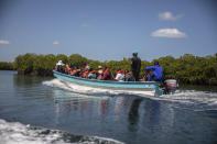 Students cross Caracol Bay as they travel on a boat after receiving a snorkeling lesson from marine biologist Jean Wiener, near Cap-Haitien, Haiti, Wednesday, March 9, 2022. “We really know that there’s a part, you know, where you can be in a classroom, but it is critically important that people actually get out and touch and see and feel the environment and see what they’re actually studying in the classroom,” Wiener said later from the hotel, where a few security guards patrolled the grounds with rifles. (AP Photo/Odelyn Joseph)