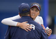 United States head coach Ken Eriksen embraces Monica Abbott after defeating Canada in their softball game at the 2020 Summer Olympics, Thursday, July 22, 2021, in Fukushima , Japan. (AP Photo/Jae C. Hong)