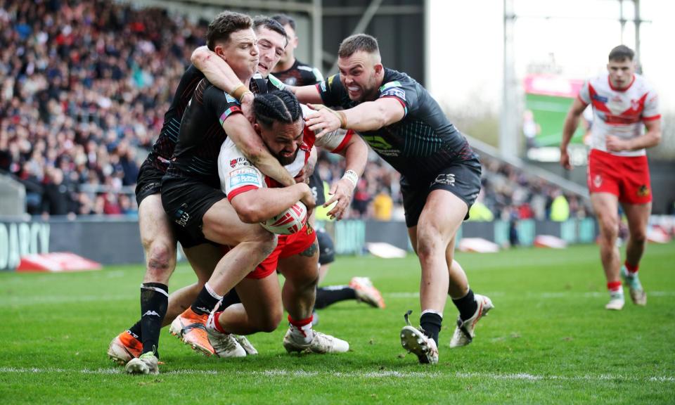 <span>Konrad Hurrell powers over to score a late try and seal St Helens' win against Wigan.</span><span>Photograph: Jess Hornby/Getty Images</span>