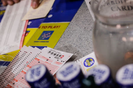 A customer buys tickets for the Powerball lottery in New York City, U.S., March 17, 2017. REUTERS/Jeenah Moon