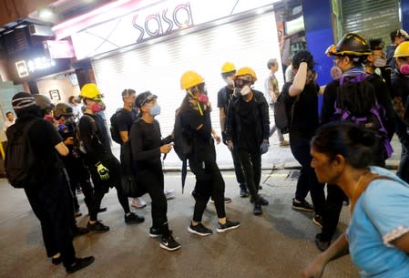 Anti-extradition bill protesters walk through Tsim Sha Tsui neighborhood in Hong Kong