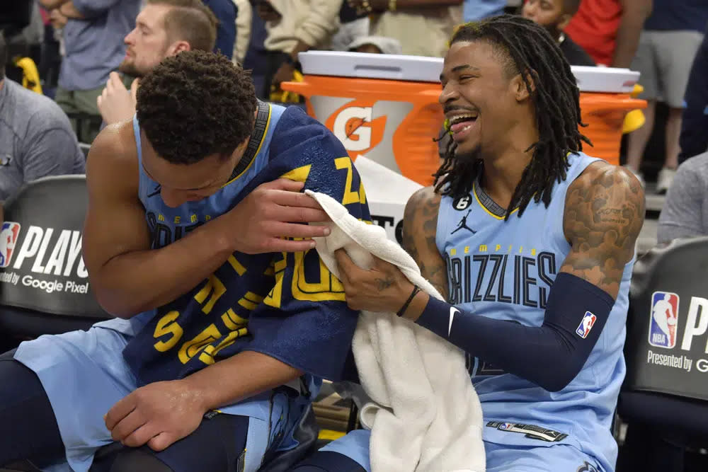 Memphis Grizzlies guards Desmond Bane, left, and Ja Morant (12) laugh on the bench during the second half of Game 5 of the team’s first-round NBA basketball playoff series against the Los Angeles Lakers on Wednesday, April 26, 2023, in Memphis, Tenn. (AP Photo/Brandon Dill)