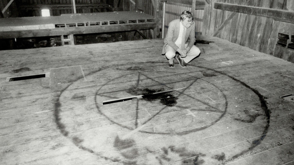 <b>A Star reporter examines a pentagram painted on the floor of a barn loft, 1964, after rumors of a Satanic cult erupted in an Ontario town.</b> Reg Innell/Toronto Star via Getty Images