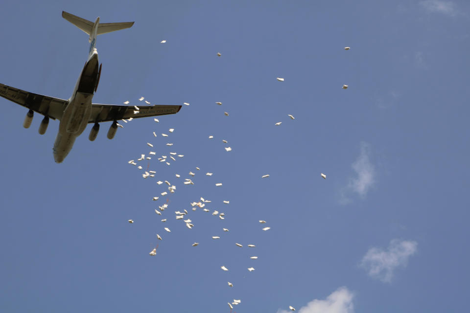 In this Friday Dec. 18 2020 photo, the World Food Program drops food aid over Pibor, South Sudan. South Sudan is one of four countries with areas that could slip into famine, the United Nations has warned, along with Yemen, Burkina Faso and northeastern Nigeria. (AP Photo/Sam Mednick)