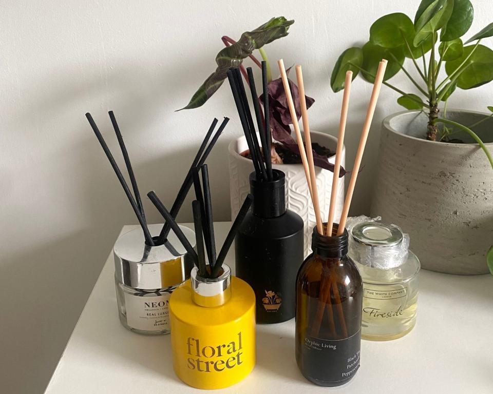 Reed diffusers from this guide in Annie's bedroom on chest of drawers with plant