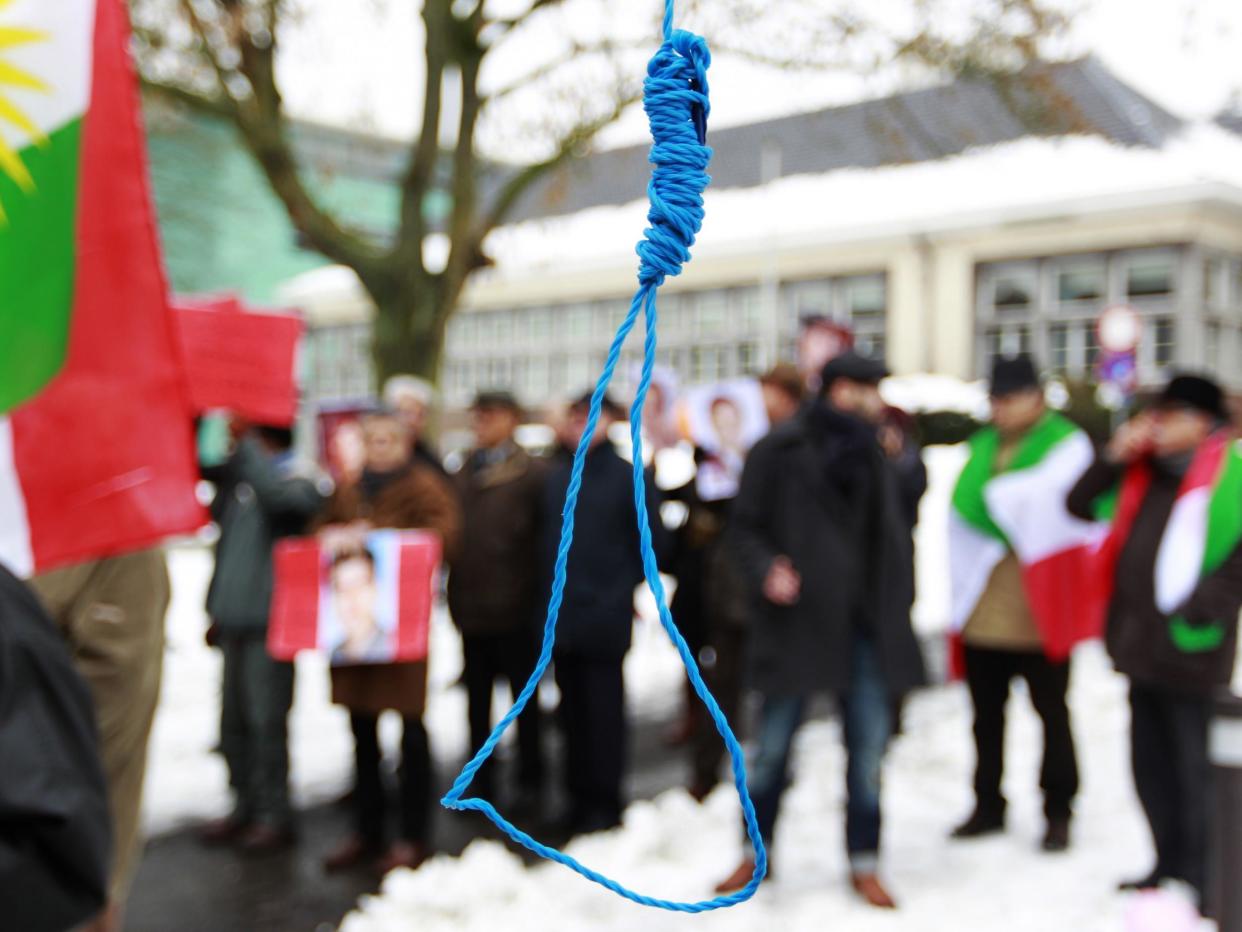 Iranian exiles shout slogans in front of a mock gallows during a demonstration in Brussels in 2010: Reuters