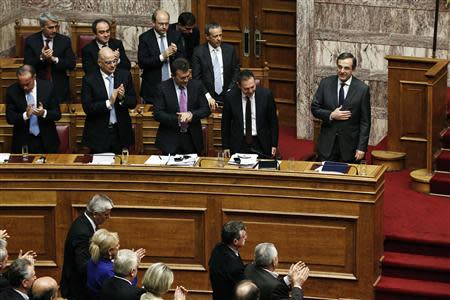 Greece's Prime Minister Antonis Samaras (R) acknowledges a round of applause from lawmakers after his speech during a parliament session where lawmakers vote on the 2014 budget in Athens December 8, 2013. REUTERS/Yorgos Karahalis