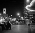 <p>People walk along Hollywood Boulevard at night. </p>
