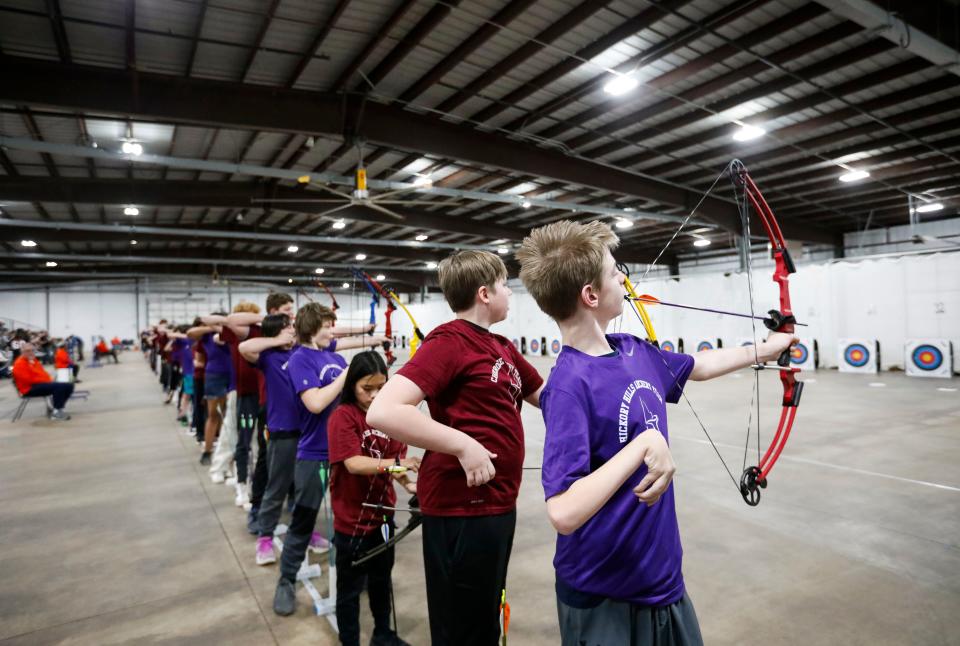 Hickory Hills Middle School seventh grader Toby Hopkins, who has limited mobility on the right side of his body, readies his bow that has been adapted to shoot using his mouth during a state-qualifying tournament at the Ozark Empire Fair Grounds Central Building on Wednesday, Jan. 31, 2024.